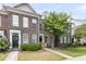 Charming brick townhome featuring a well-manicured lawn and welcoming front entrance at 822 Rue Dr, Charleston, SC 29414