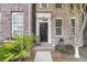 Elegant brick townhome entrance with decorative plants and a welcoming walkway at 822 Rue Dr, Charleston, SC 29414