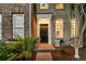 Elegant brick townhome entrance with decorative plants and a welcoming walkway at 822 Rue Dr, Charleston, SC 29414