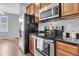 Modern kitchen with granite countertops, wood cabinets, and stainless steel appliances at 822 Rue Dr, Charleston, SC 29414