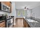 Kitchen with stainless appliances, granite countertops, and an open view to the living area at 822 Rue Dr, Charleston, SC 29414