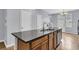 Kitchen island with granite countertop, stainless dishwasher, and wood cabinets at 822 Rue Dr, Charleston, SC 29414