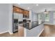 Modern kitchen with stainless steel appliances and a gray granite countertop island at 822 Rue Dr, Charleston, SC 29414