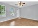 Bright living room with natural light, wood floors, and a view of the front yard at 822 Rue Dr, Charleston, SC 29414
