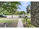 Charming brick-lined walkway leading to parked cars and lush, shady trees at 822 Rue Dr, Charleston, SC 29414