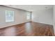 Bright bedroom featuring hardwood floors, recessed lighting, and two windows providing natural light at 8632 Madelyn St, North Charleston, SC 29406