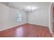 Dining room with hardwood floors, chandelier, and large window with natural light at 8632 Madelyn St, North Charleston, SC 29406