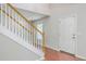 Foyer featuring hardwood floors, stairs with wood railing and white door at 8632 Madelyn St, North Charleston, SC 29406