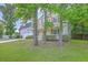 View of a two story home surrounded by trees on a well-manicured lawn at 8632 Madelyn St, North Charleston, SC 29406
