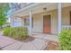 View of the front porch with white railings and trim around the front door at 8632 Madelyn St, North Charleston, SC 29406