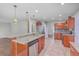 Spacious kitchen featuring stainless steel appliances, granite countertops, a breakfast bar, and modern lighting at 8632 Madelyn St, North Charleston, SC 29406