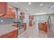 Well-lit kitchen with stainless steel appliances, granite countertops, tile backsplash, and ample cabinet space at 8632 Madelyn St, North Charleston, SC 29406