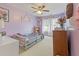 Playful bedroom with lavender walls, and a ceiling fan at 9206 Southern Oak Ln, Ladson, SC 29456