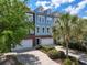 Charming townhouse featuring a two-car garage, lovely landscaping, and a welcoming entrance at 9206 Southern Oak Ln, Ladson, SC 29456