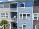 Three-story condo exterior with multiple balconies and blue, tan, and brown siding at 9206 Southern Oak Ln, Ladson, SC 29456