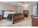 Relaxing main bedroom with ample space, featuring dark wood furniture and a ceiling fan at 9206 Southern Oak Ln, Ladson, SC 29456