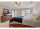 Comfortable main bedroom featuring neutral walls, dresser with TV and access to a private outdoor patio at 9206 Southern Oak Ln, Ladson, SC 29456