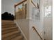 Welcoming staircase leading to the upper level, naturally lit by a stylish light fixture at 9206 Southern Oak Ln, Ladson, SC 29456