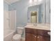 Cozy bathroom with updated vanity, toilet, bathtub, and shower with complementary blue painted walls at 9418 Sweep Dr, Summerville, SC 29485