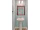 Bathroom with pedestal sink, classic mirror, modern fixtures, and a clean and inviting space at 9418 Sweep Dr, Summerville, SC 29485
