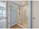 Bathroom with a clear glass shower stall, light blue walls, and doorway into the bedroom at 9418 Sweep Dr, Summerville, SC 29485