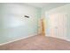 Well lit bedroom with carpet, light teal painted walls, a closet, and an open doorway at 9418 Sweep Dr, Summerville, SC 29485