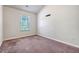 Empty carpeted bedroom with light walls and a window looking out to a green leafy tree at 9418 Sweep Dr, Summerville, SC 29485