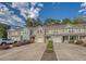 Street view showcasing charming townhomes with colorful exteriors, attached garages, and manicured landscaping at 9418 Sweep Dr, Summerville, SC 29485