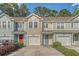 Charming townhomes featuring colorful exteriors, attached garages and well-maintained landscaping enhance curb appeal at 9418 Sweep Dr, Summerville, SC 29485
