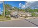 Charming street view of townhomes with attached garages and colorful exteriors, set amongst mature trees at 9418 Sweep Dr, Summerville, SC 29485