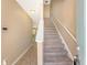 Inviting foyer with neutral walls, carpeted staircase, and wood-look flooring creates a warm welcome at 9418 Sweep Dr, Summerville, SC 29485