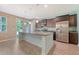 Open kitchen with granite countertops, stainless steel appliances, and a large central island and view of outdoors at 9418 Sweep Dr, Summerville, SC 29485