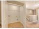 A look into the laundry room with washer and dryer hookups and overhead shelving at 9418 Sweep Dr, Summerville, SC 29485