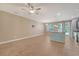 Open-concept living room featuring wood-look flooring, flowing seamlessly into the kitchen area with center island at 9418 Sweep Dr, Summerville, SC 29485