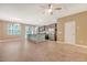 Open-concept living area flows into kitchen with center island, stainless steel appliances, and ample natural light at 9418 Sweep Dr, Summerville, SC 29485