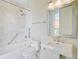 Bathroom with white marble, shower-tub combination and modern fixtures and lighting at 1 Vendue Range # I, Charleston, SC 29401