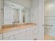 Bathroom featuring double sinks with stone countertops and white cabinets at 1 Vendue Range # I, Charleston, SC 29401
