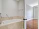 Bathroom with large soaking tub and tile surround adjacent to bedroom at 1 Vendue Range # I, Charleston, SC 29401