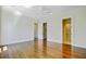 Spacious bedroom with hardwood floors and neutral walls, showcasing an open closet and bathroom at 1 Vendue Range # I, Charleston, SC 29401