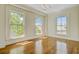 Bedroom with lots of natural light from large windows and hardwood floors at 1 Vendue Range # I, Charleston, SC 29401