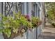Charming building exterior with window boxes filled with beautiful flowers along street at 1 Vendue Range # I, Charleston, SC 29401