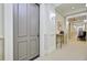 Hallway view highlighting an entrance door, decorative trim, and an artfully decorated side table at 1 Vendue Range # I, Charleston, SC 29401