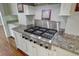 Close up of kitchen cooktop with stainless steel Thermador range and granite countertops at 1 Vendue Range # I, Charleston, SC 29401