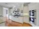 Well-appointed kitchen featuring custom white cabinets, stainless steel appliances, and granite countertops at 1 Vendue Range # I, Charleston, SC 29401