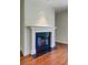 Cozy fireplace with white mantel and black tile in a traditional living room at 1 Vendue Range # I, Charleston, SC 29401