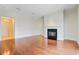 Bright, spacious living room with a fireplace, elegant trim, and wood flooring at 1 Vendue Range # I, Charleston, SC 29401