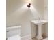 Classic powder room featuring a pedestal sink and wall sconce at 1 Vendue Range # I, Charleston, SC 29401