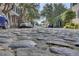Charming cobblestone street lined with parked cars and lush green trees at 1 Vendue Range # I, Charleston, SC 29401