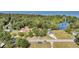 Aerial view of home nestled amongst mature trees near lake and water access at 107 Jacks Ln, Bonneau, SC 29431