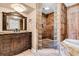 Elegant bathroom featuring an ornate vanity, tiled walk-in shower, and a soaking tub at 107 Jacks Ln, Bonneau, SC 29431